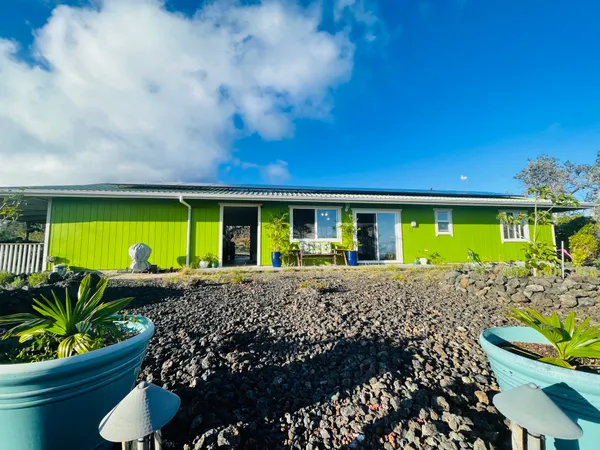 a view of a house with a porch and furniture