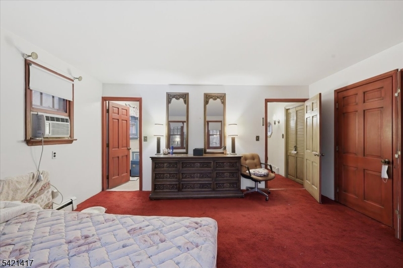 100 Old Croton Road Flemington, NJ 08822 - Photo 21 of 39 a bedroom with a bed and a chandelier