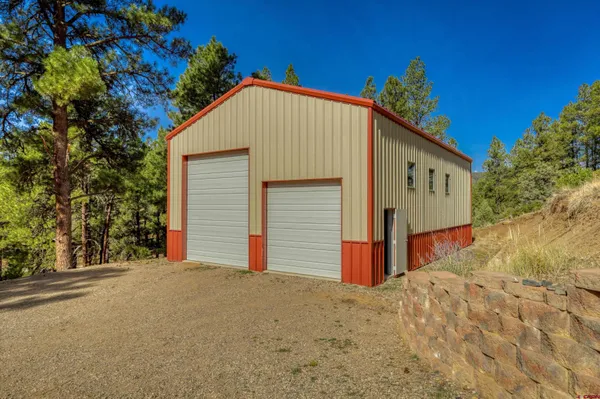 a view of a house with a yard and garage