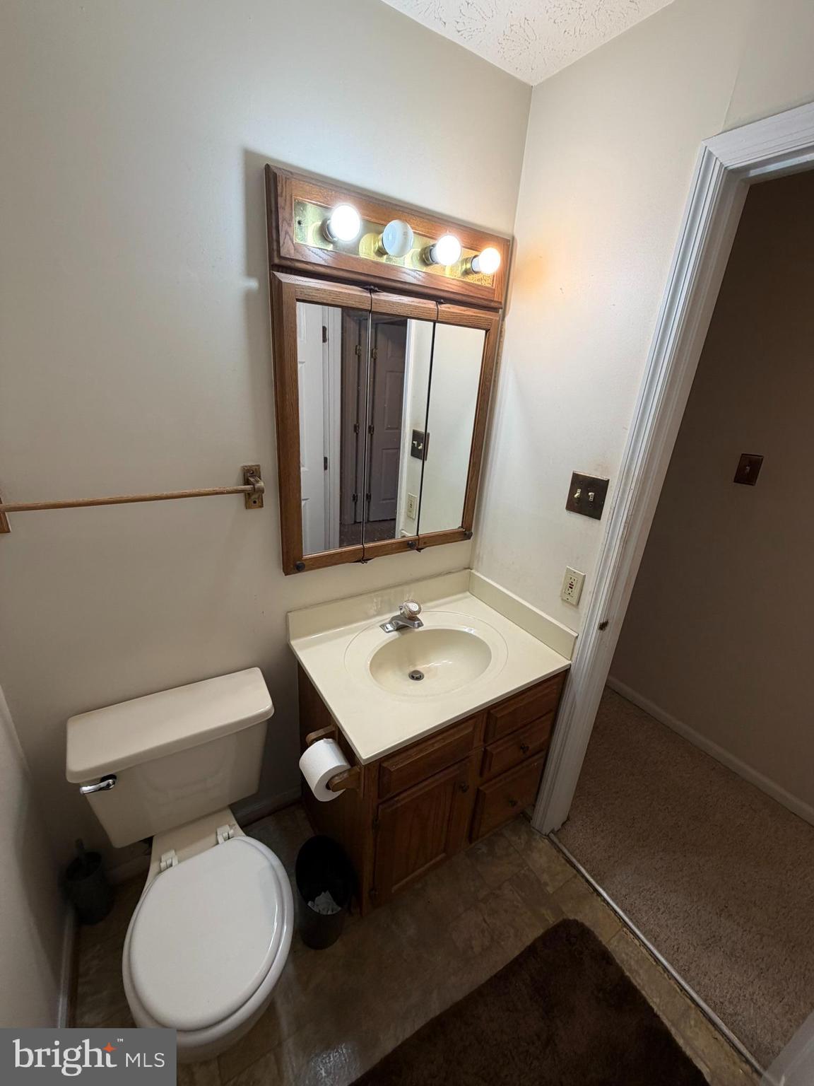 1305 Clover Valley Way, Unit 1305 Edgewood, MD 21040 - Photo 29 of 44 a bathroom with a toilet a sink and mirror