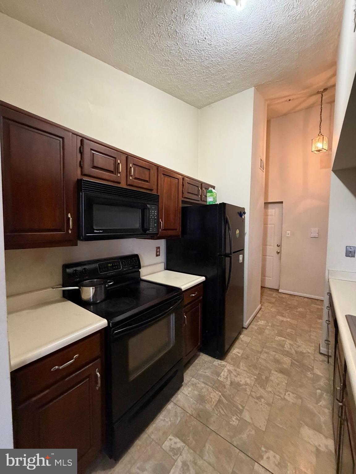 1305 Clover Valley Way, Unit 1305 Edgewood, MD 21040 - Photo 8 of 44 a kitchen with stainless steel appliances a stove and a refrigerator