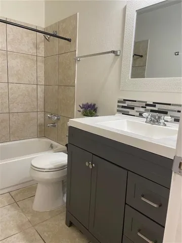 a bathroom with a toilet a sink and bathtub