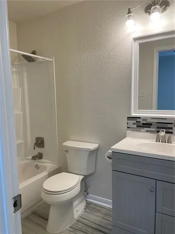 a bathroom with a sink toilet and mirror