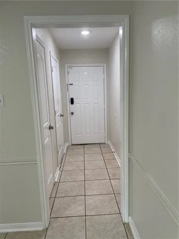 a view of an empty room with a fireplace and a window