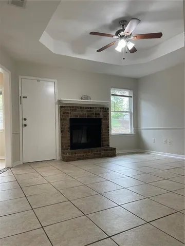 an empty room with fireplace and windows