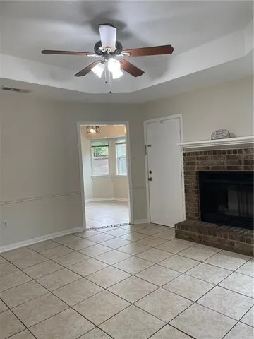 a view of an empty room and window chandelier fan