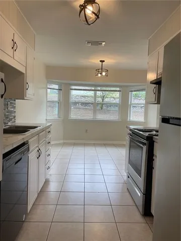 a kitchen with a sink and cabinets