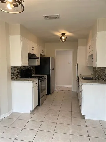 a kitchen with stainless steel appliances granite countertop a sink and cabinets