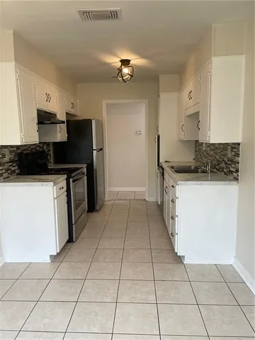 a kitchen with granite countertop white cabinets and white appliances