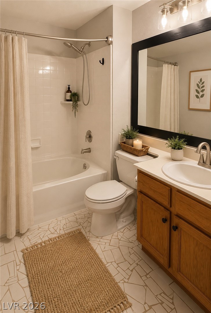 346 Seine Way Henderson, NV 89014 - Photo 11 of 24 A pristine bathroom features mosaic tile flooring, a shower-over-tub combination, and a modern vanity with a large mirror.