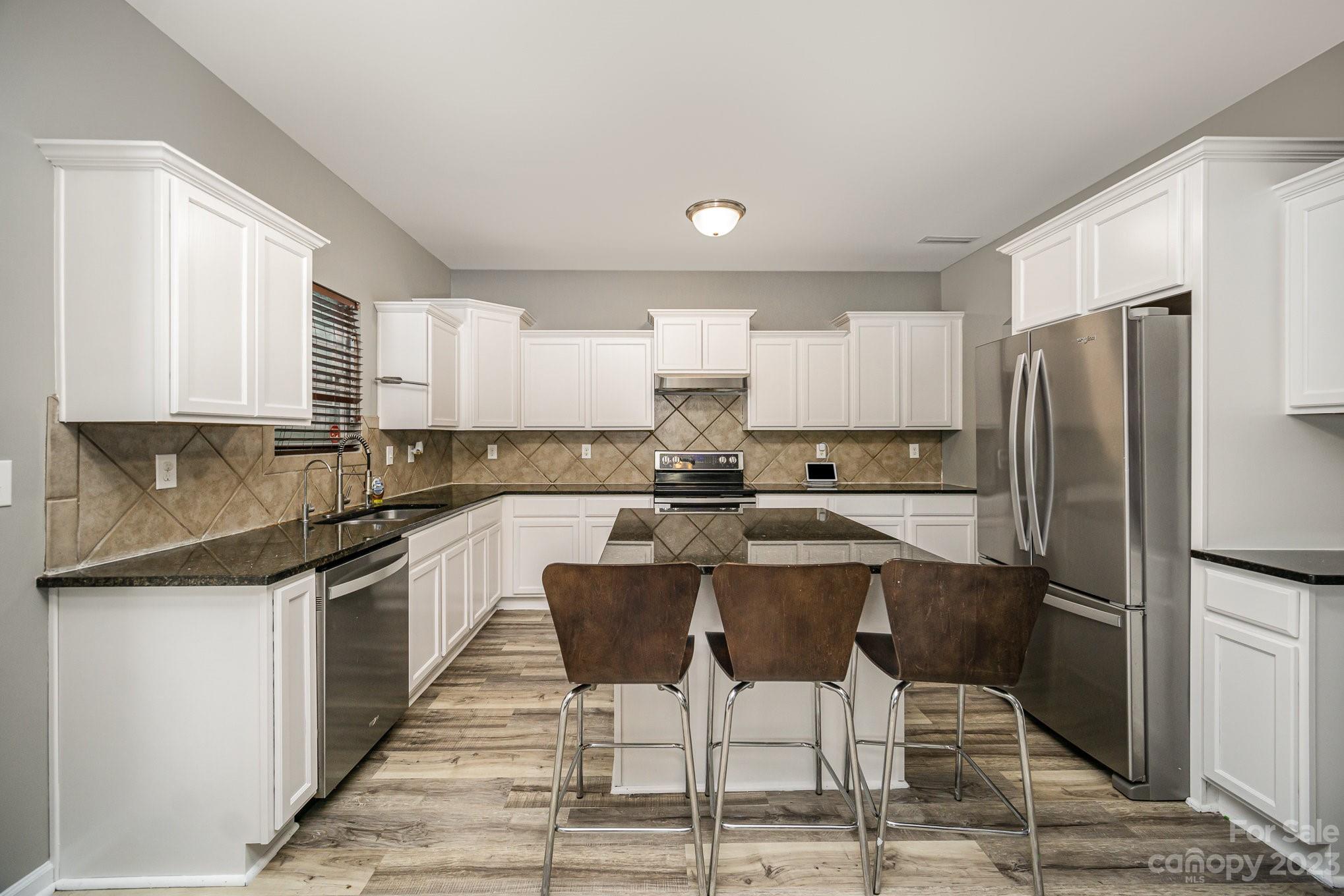 175 Old Carriage Road Clover, SC 29710 - Photo 11 of 34 a kitchen with stainless steel appliances granite countertop a refrigerator and a stove top oven