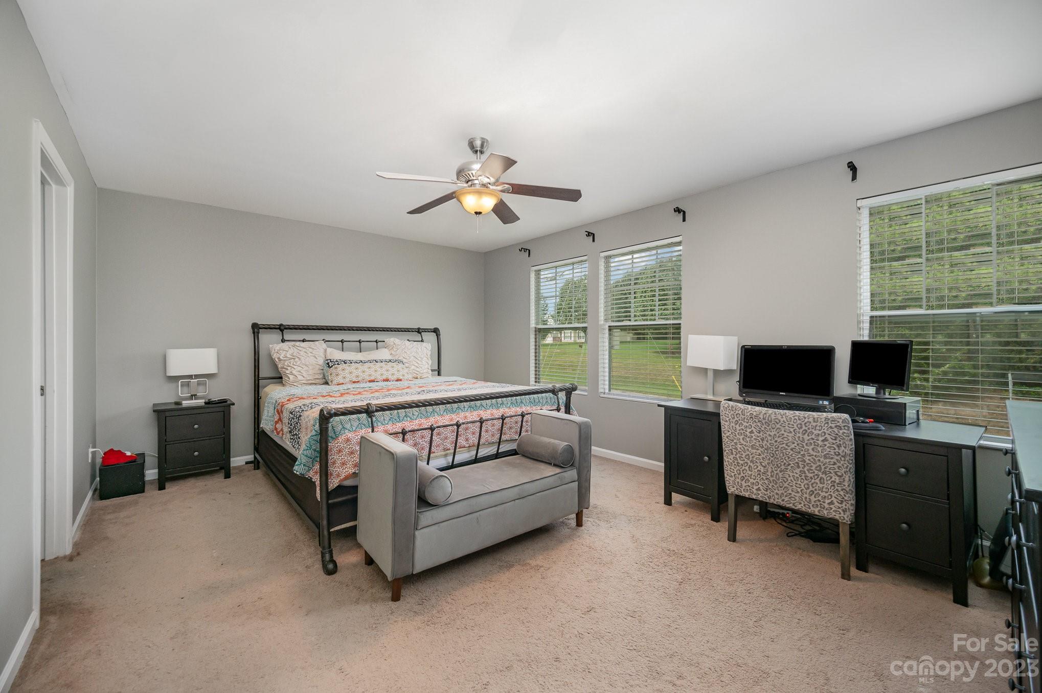 175 Old Carriage Road Clover, SC 29710 - Photo 20 of 34 a bedroom with a bed and a chandelier