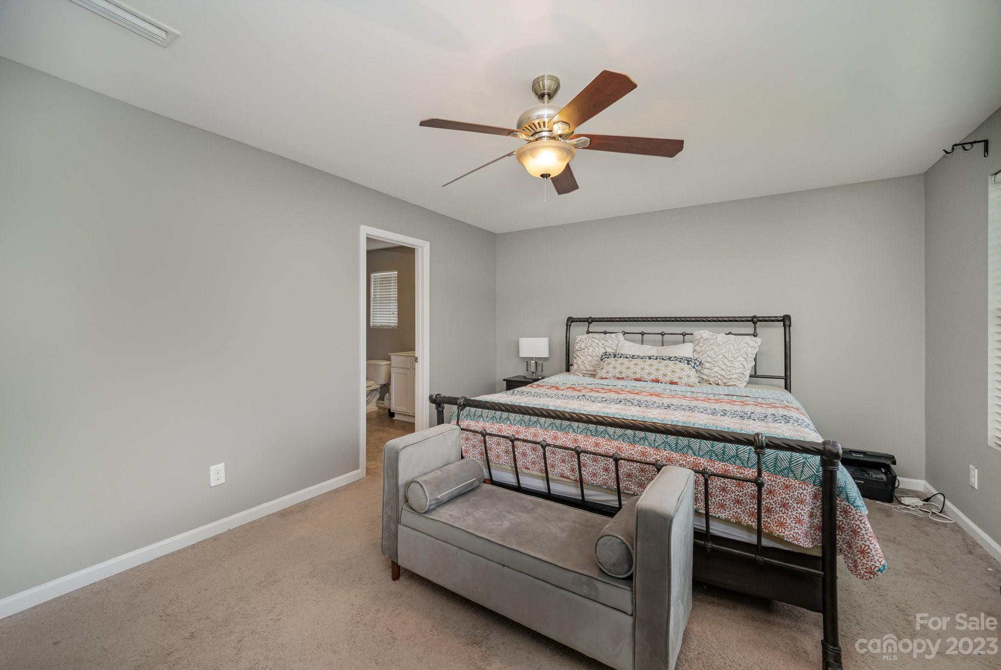 175 Old Carriage Road Clover, SC 29710 - Photo 21 of 34 a bedroom with a bed and a chandelier
