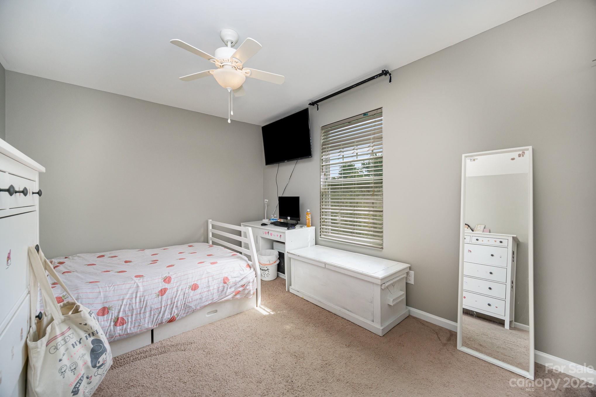 175 Old Carriage Road Clover, SC 29710 - Photo 25 of 34 a bedroom with a bed and a chandelier