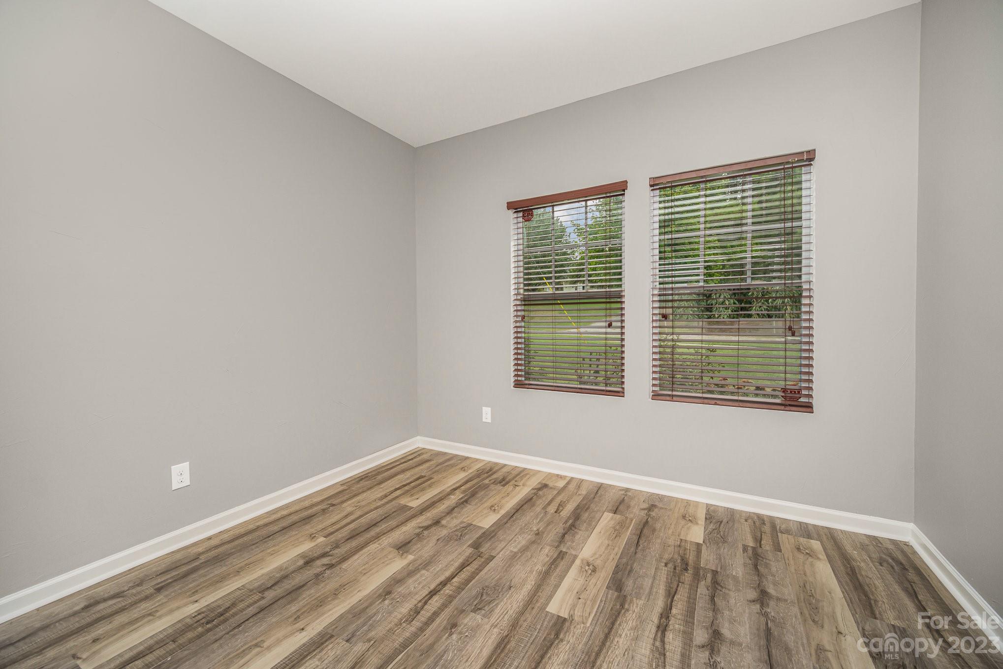 175 Old Carriage Road Clover, SC 29710 - Photo 5 of 34 a view of an empty room with wooden floor and a window