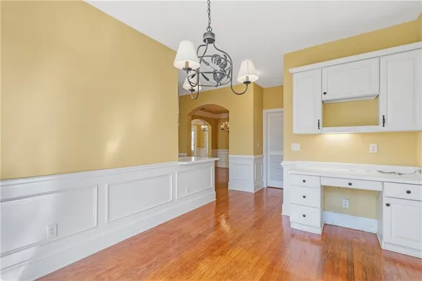 a kitchen with stainless steel appliances white cabinets and a stove top oven