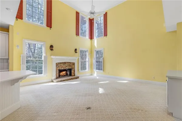 a spacious bathroom with a sink double vanity granite and a window