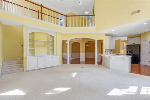 a view of an empty room with a window and a ceiling fan