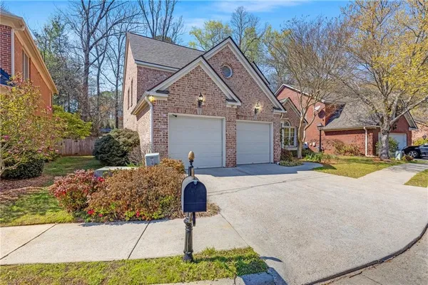 a view of a livingroom with a chandelier fan front door and wooden floor