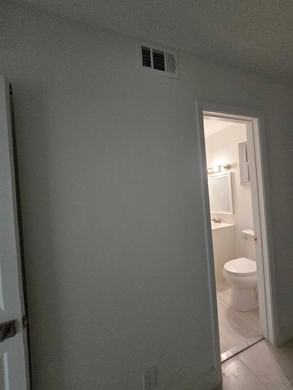 8657 Southwest 5th Street, Unit 201 Pembroke Pines, FL 33025 - Photo 15 of 15 a white toilet sitting next to a white sink