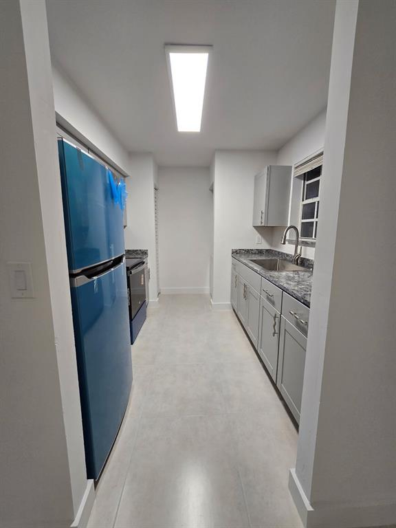 8657 Southwest 5th Street, Unit 201 Pembroke Pines, FL 33025 - Photo 3 of 15 a kitchen with stainless steel appliances granite countertop a refrigerator a sink a stove a microwave a sink and dishwasher