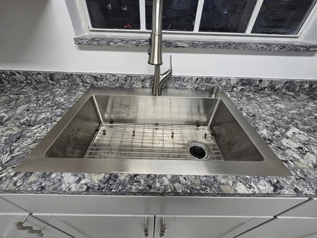 a kitchen with a stove a sink and a microwave