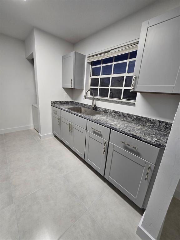 8657 Southwest 5th Street, Unit 201 Pembroke Pines, FL 33025 - Photo 5 of 15 a kitchen with granite countertop white cabinets and white stainless steel appliances