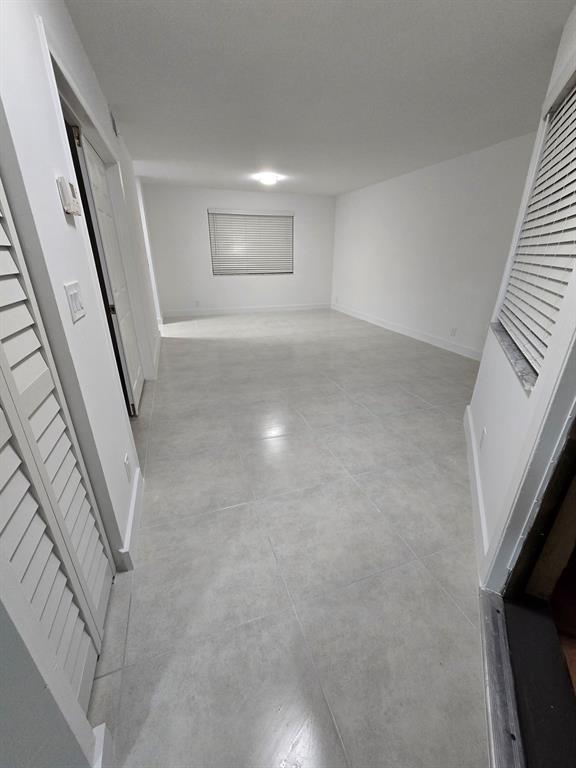 8657 Southwest 5th Street, Unit 201 Pembroke Pines, FL 33025 - Photo 6 of 15 wooden floor in an empty room with a window