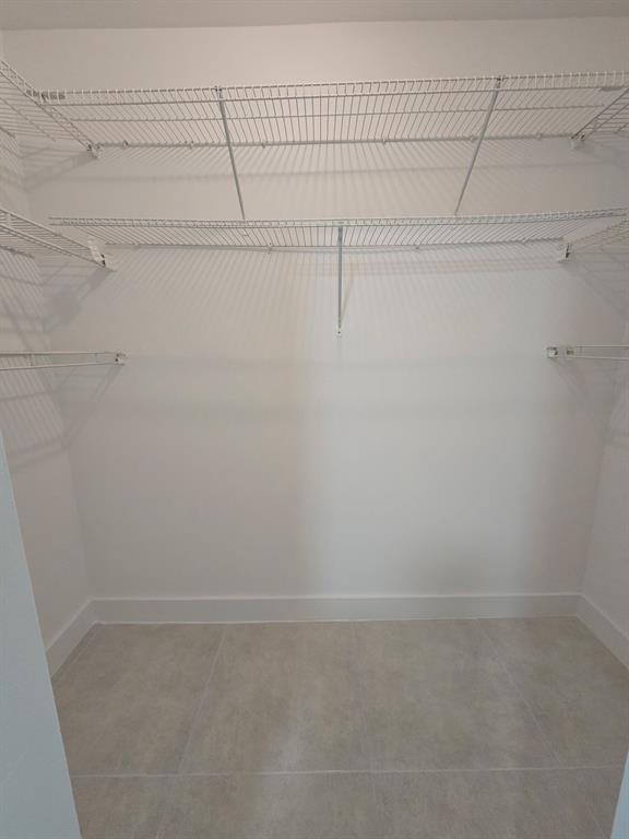 8657 Southwest 5th Street, Unit 201 Pembroke Pines, FL 33025 - Photo 7 of 15 a view of a room with racks on the wall