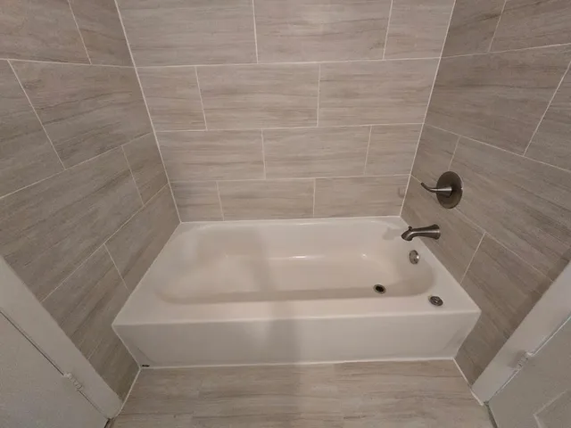 a bathroom with a white bath tub