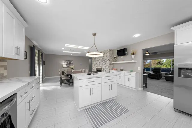 a kitchen with granite countertop a sink stove and cabinets