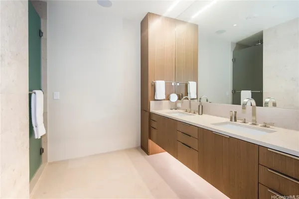 a bedroom with a bed and a flat tv screen on dresser