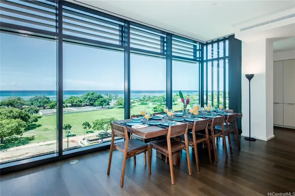a living room with furniture and a floor to ceiling window