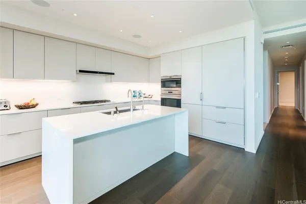 a kitchen that has a sink and a stove in it