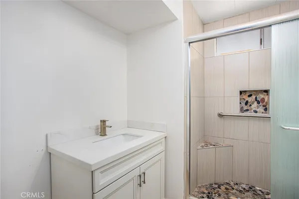 a bathroom with a sink a vanity and a shower