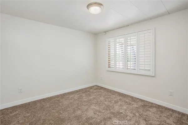an empty room with a empty space and a window