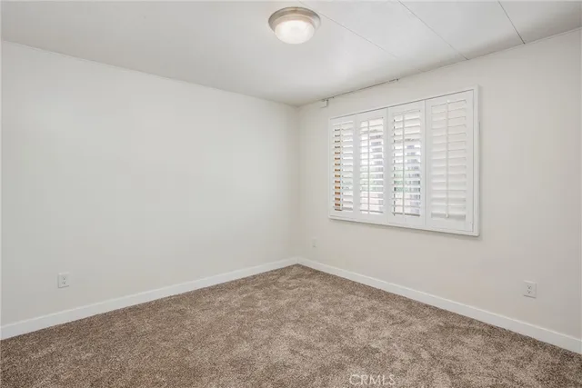 an empty room with a empty space and a window