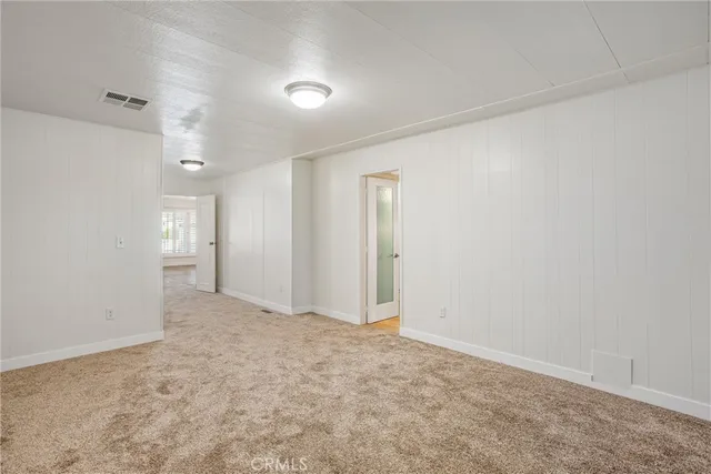 a spacious bathroom with a granite countertop sink and mirror