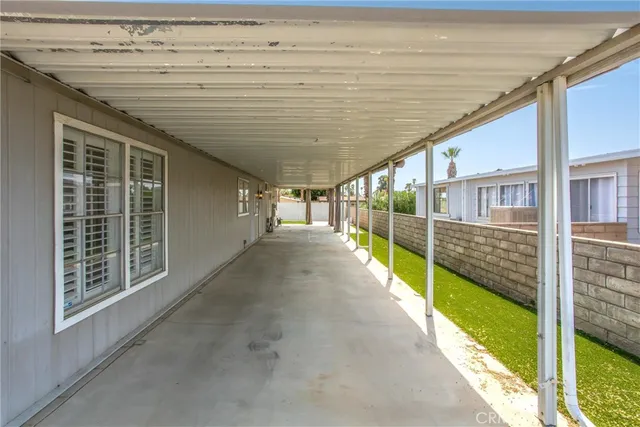 a view of a backyard with a garden and deck