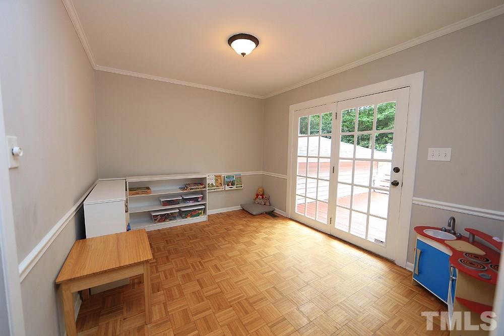 6004 Spring Valley Drive Raleigh, NC 27616 - Photo 7 of 25 This room could have many uses, a den, children's play area, or another home office. Doors lead to deck.