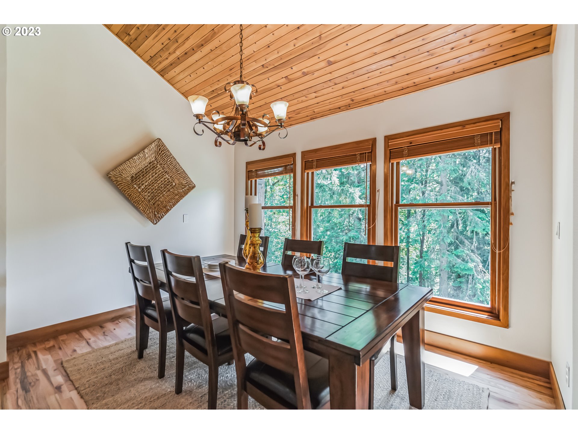18282 South Sam McGee Road Oregon City, OR 97045 - Photo 8 of 47 a view of a dining room with furniture a chandelier and wooden floor