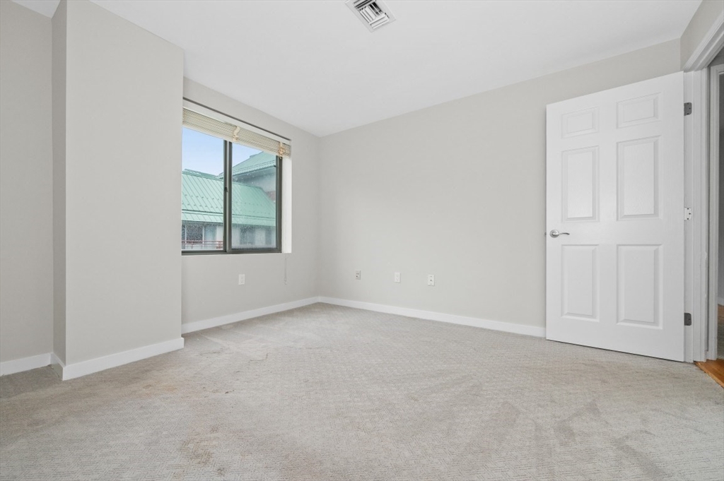 183 Oak Street, Unit 307 Newton, MA 02464 - Photo 13 of 24 an empty room with windows