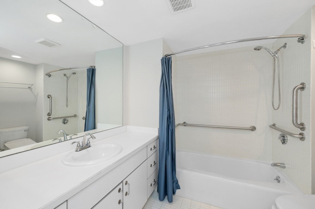 183 Oak Street, Unit 307 Newton, MA 02464 - Photo 14 of 24 a bathroom with a tub sink mirror and a shower