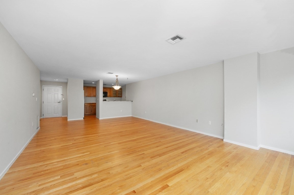 183 Oak Street, Unit 307 Newton, MA 02464 - Photo 7 of 24 a view of empty room with wooden floor