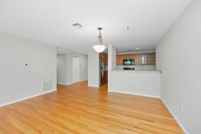 a view of a kitchen with granite countertop cabinets and wooden floor
