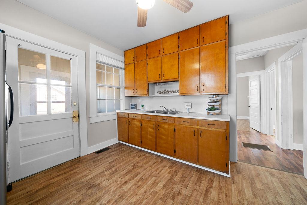 14 Green Street Northeast Rome, GA 30161 - Photo 13 of 24 a kitchen with stainless steel appliances granite countertop a sink cabinets and wooden floor