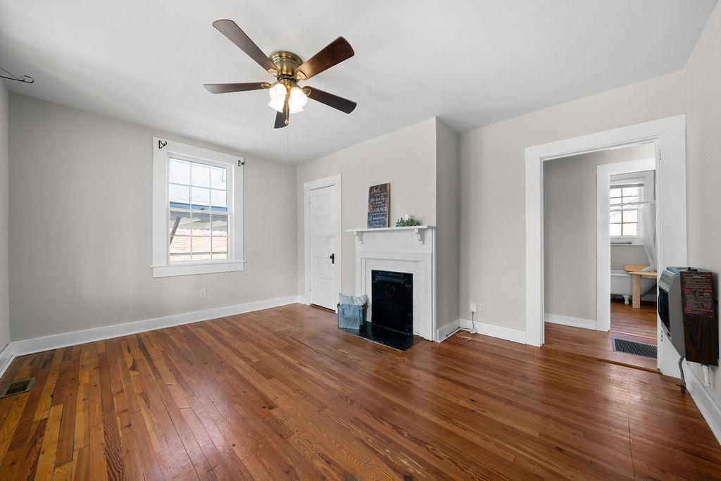 14 Green Street Northeast Rome, GA 30161 - Photo 7 of 24 a view of empty room with wooden floor and fireplace