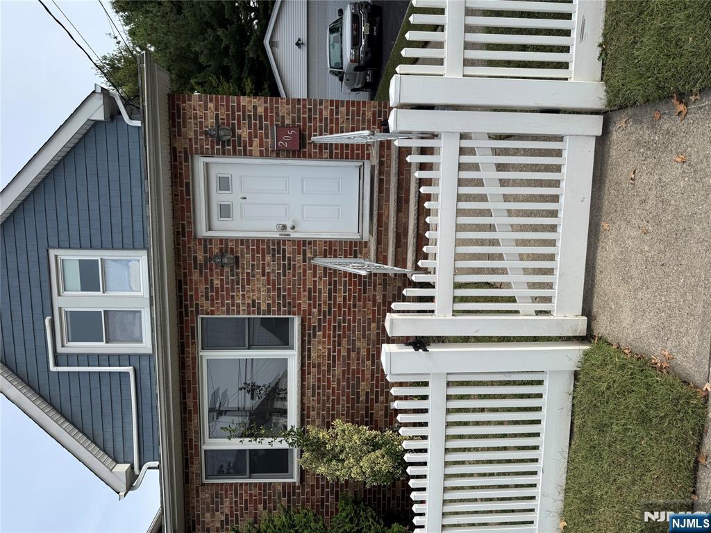 205 Valley Brook Avenue, Unit 2 Lyndhurst, NJ 07071 - Photo 1 of 5 a front view of a house with a garden