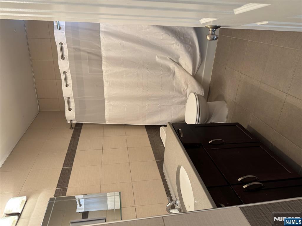 205 Valley Brook Avenue, Unit 2 Lyndhurst, NJ 07071 - Photo 5 of 5 a bathroom with a sink and a mirror