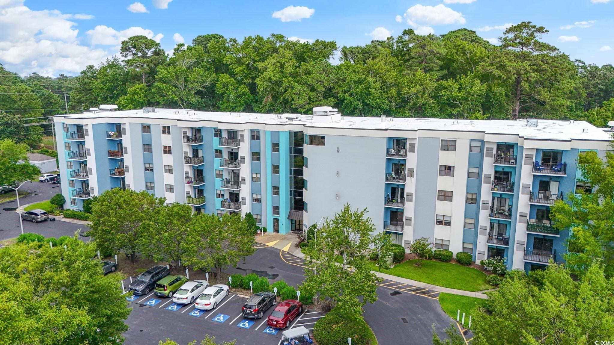 5001 Little River Road, Unit W106 Myrtle Beach, SC 29577 - Photo 1 of 28 View of apartment building / complex with uncovered parking